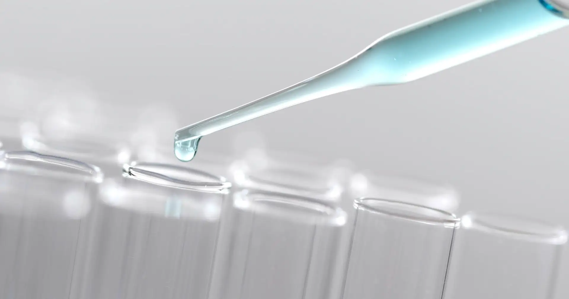 Drop of liquid falling into a test tube during water analysis, Oakwater Laboratories